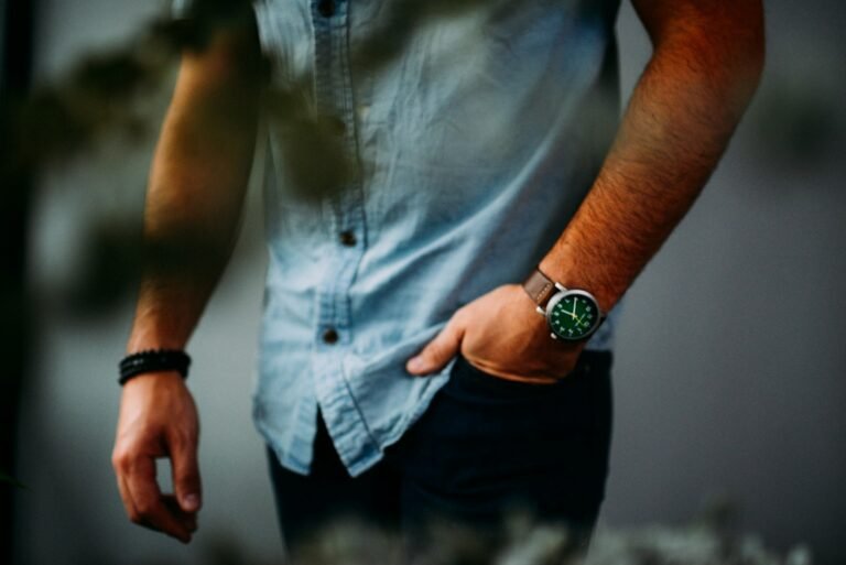 Man wearing a blue denim shirt with one hand in his pocket