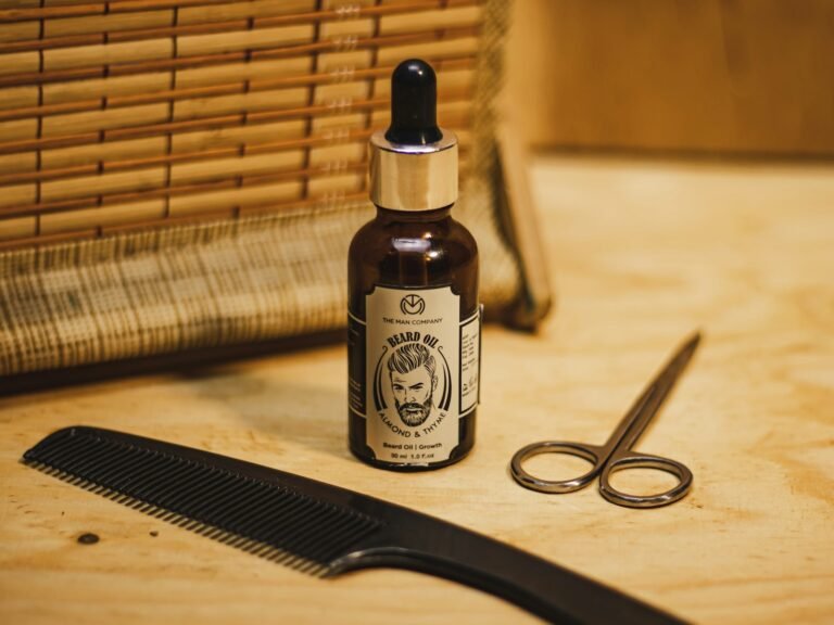 Bottle of natural beard oil next to grooming scissors