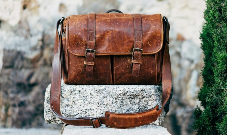 Brown leather satchel bag on a concrete surface