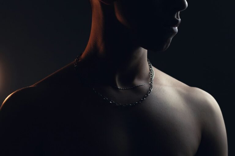Man wearing a necklace, an example of men's neck jewellery style