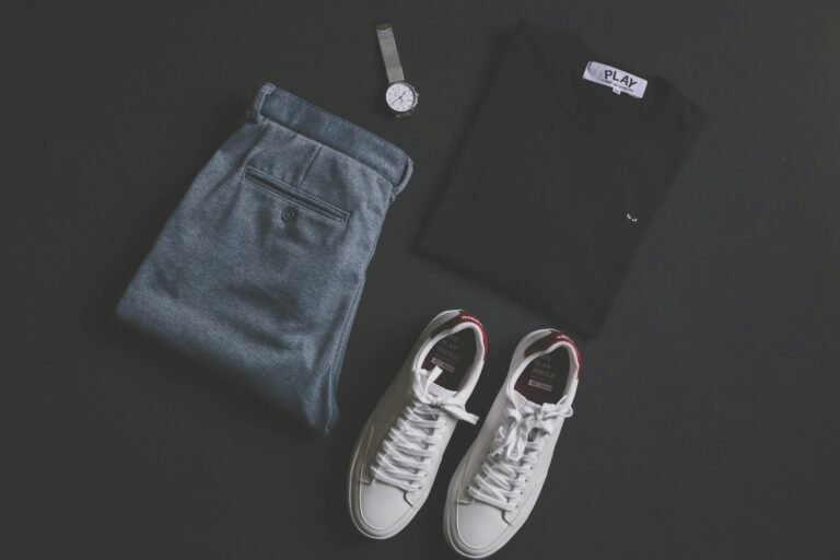 Flat lay of a men's outfit with trousers, shirt and accessories