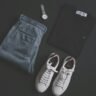 Flat lay of a men's outfit with trousers, shirt and accessories