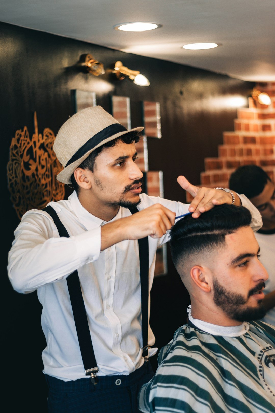 Man getting his hair cut by a barber